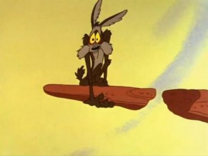 Wile E. Coyote falling off a cliff, holding a rock that is attached to nothing.